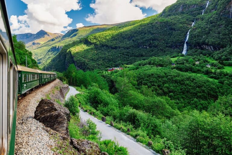 Foto vanuit de trein gemaakt rondom het dorpje Flåm. Uitzicht op de groene natuur en bergen