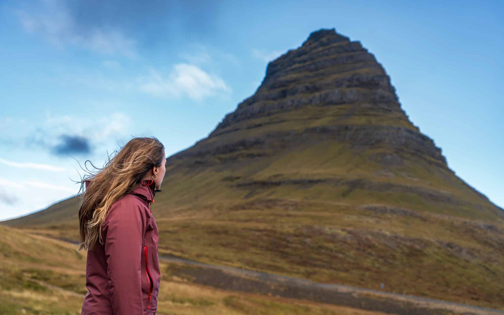 Vrouw staat voor Kirkjufell berg, Snaefellsnes, IJsland