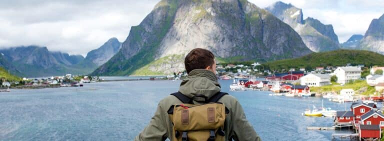 Man kijkt uit over dorp met berg op de achtergrond op de Lofoten, Noorwegen