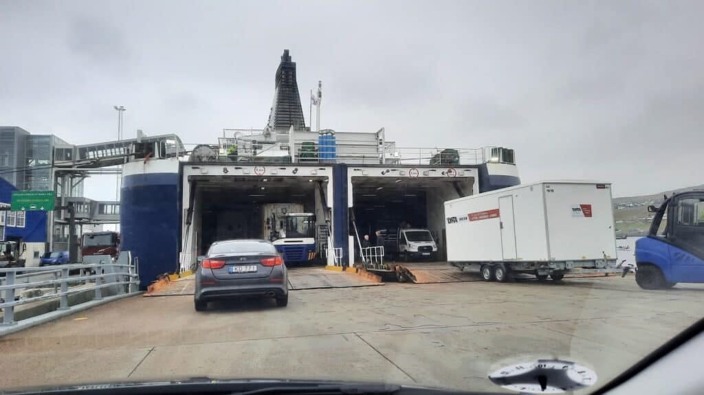 Auto rijdt de ferry op in de Faeröer eilanden.