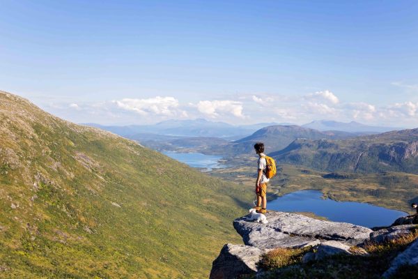 Tiener uitkijkend over vallei in Noorwegen.