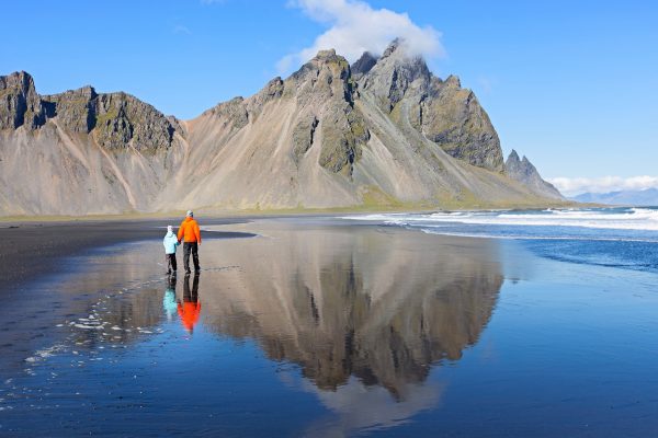 Family,Of,Two,,Father,And,Son,,Walking,At,Black,Sand