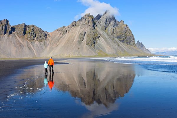 Family,Of,Two,,Father,And,Son,,Walking,At,Black,Sand